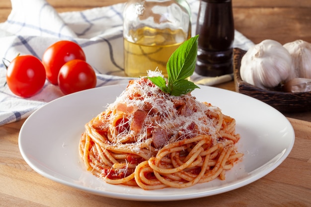 Spaghetti in a dish on a wooden background