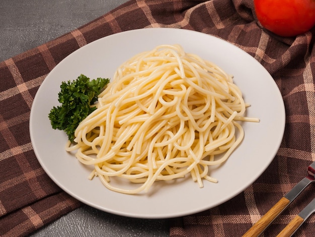 Spaghetti is a traditional Italian pasta decorated with herbs