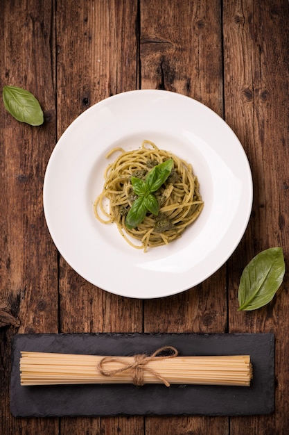 Spaghetti Pesto alla Genovese on rustic wooden table