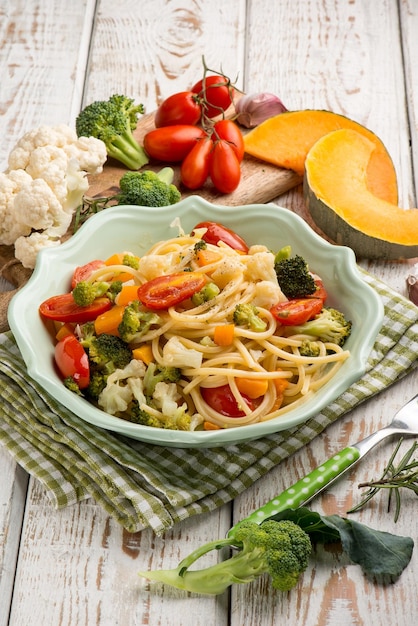 Spaghetti with broccoli cabbage pumpkin and tomatoes