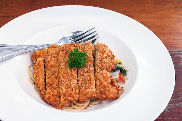 Spaghetti with fried pork sauce on a plate