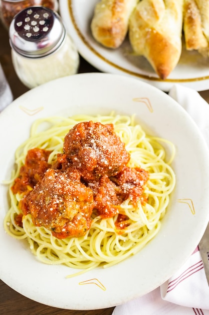 Spaghetti with meatballs on the plate in Italian restaurant.