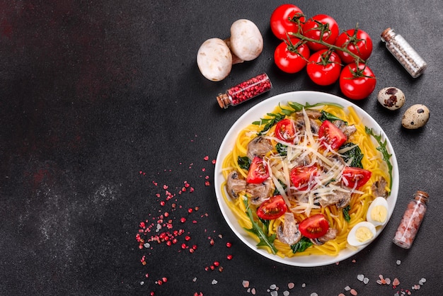 Spaghetti with mushrooms, cheese, spinach, rukkola and cherry tomatoes. Italian dish, Mediterranean culture