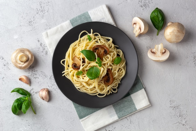 Spaghetti with mushrooms and cream sauce on a light space