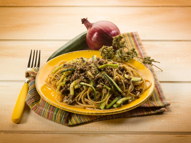 Spaghetti with ragout and zucchinis