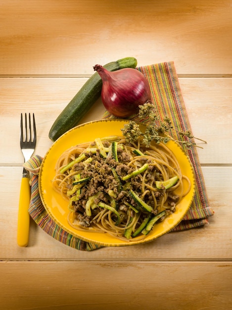 Spaghetti with ragout and zucchinis