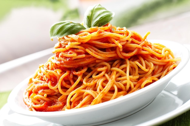 Spaghetti with tomato sauce and basil on a plate