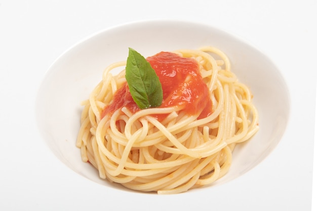 Spaghetti with tomato sauce, photo on the white background close up