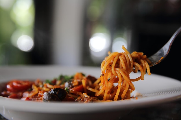 Spaghetti witn tomato and olive , Italian food