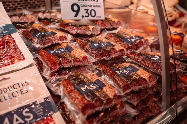 SPAIN BARCELONA October 14 2022 Spanish sausages and serrano jamon on the La Boqueria Market in Barcelona Spain