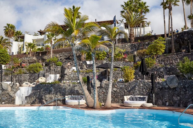 Spain, Canarias, Santa Cruz de Tenerife, Adeje - December 19, 2019: Seaside resort at summer day. Sun loungers.