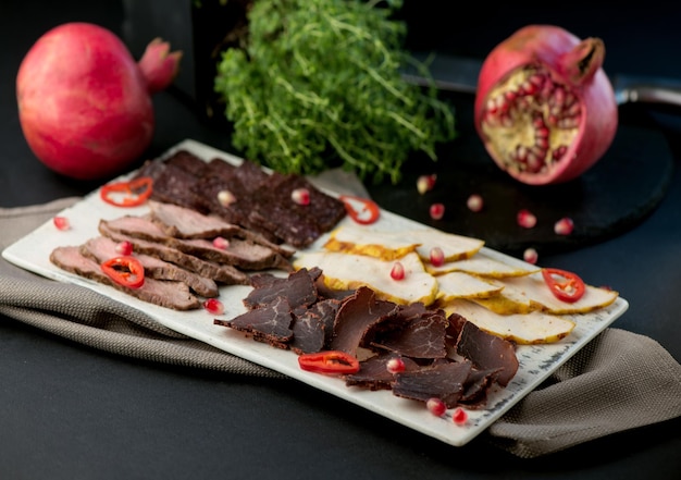 Spanish cold meat assortment Chorizo fuet LOMO jamon Iberico olives Black background Top view