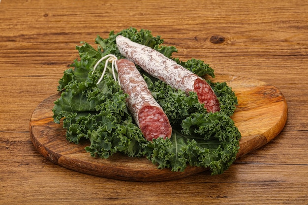 Spanish Fuet sausage with salad leaves