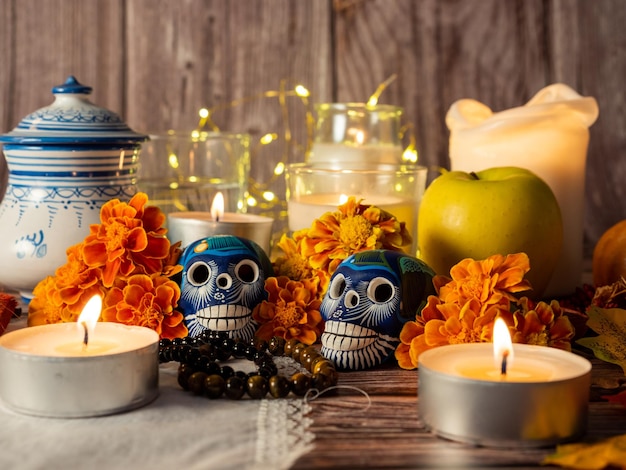 Spanish Mexican traditional autumn festival day of the dead typical Mexican skull with flowers painted on wood background decorations and marigold flowers