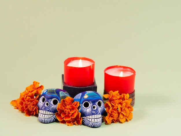 Spanish Mexican traditional autumn festival day of the dead typical Mexican skull with flowers painted on wood background decorations and marigold flowers