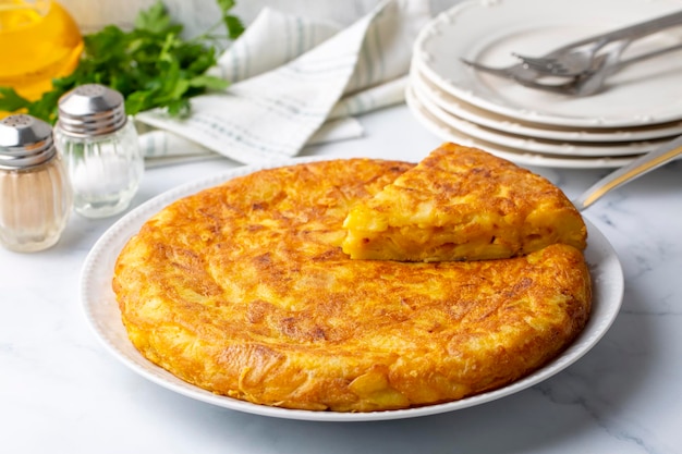 Spanish omelette with potatoes, typical spanish cuisine on gray concrete floor. Tortilla Espanola. Turkish name; Yumurtali patates