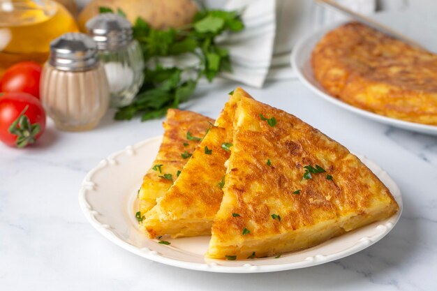 Spanish omelette with potatoes, typical spanish cuisine on gray concrete floor. Tortilla Espanola. Turkish name; Yumurtali patates