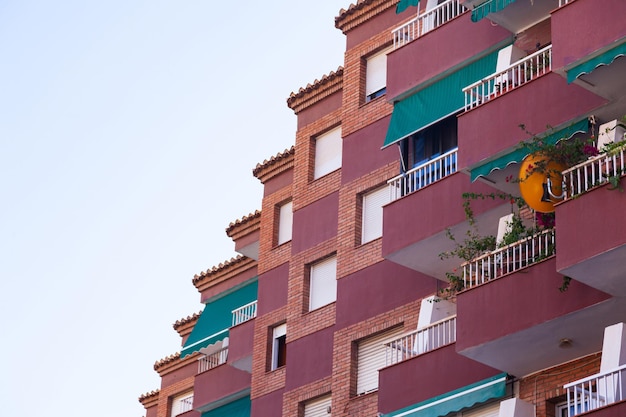 Spanish residential multistorey brick house with balconies