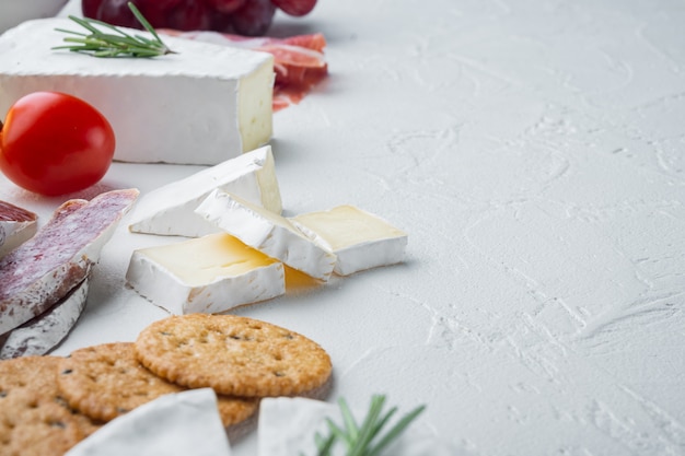 Spanish snacks, meat cheese, herbs set, on white table 