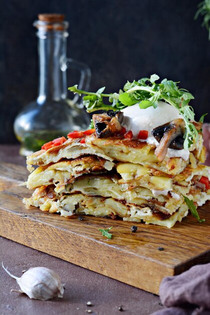 Spanish tortilla traditional omelette with creamy fresh potatoes mushrooms and fresh arugula