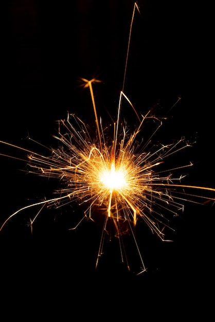 Sparkler candle used in celebrations black background selective focus