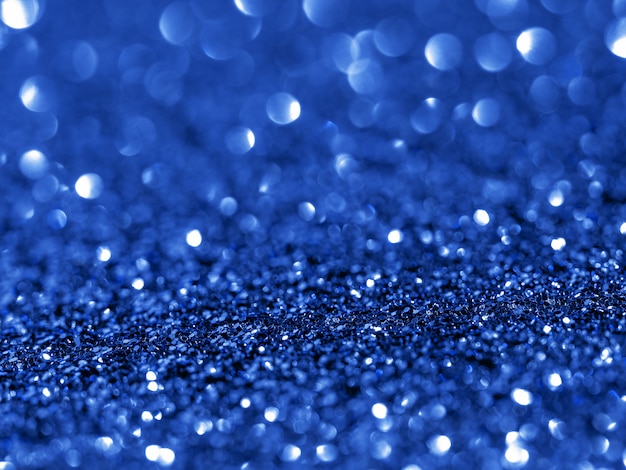 Sparkling background with bokeh made of Classic Blue 2020 color.