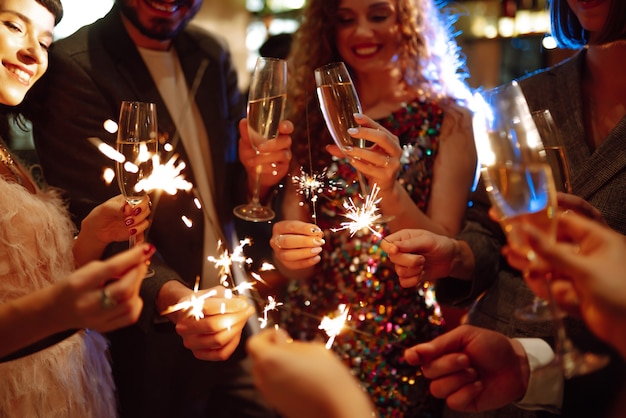 Sparkling sparklers in the hands. Playing firework to celebrate winter holidays. Magic New Year.