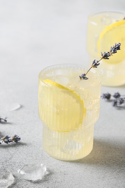 Sparkling summer lavender lemonade in glasses on gray background