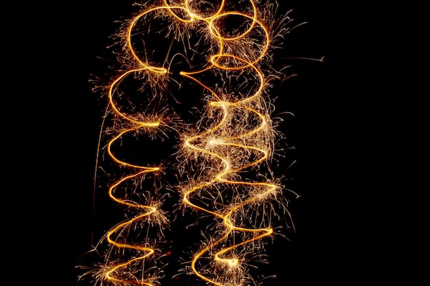 Sparks of Bengal lights on a long exposure Christmas lights on a black background