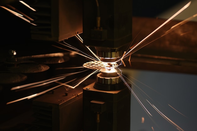 Sparks from automatic laser cutting or engraving of parts closeup laser cutting metal concept