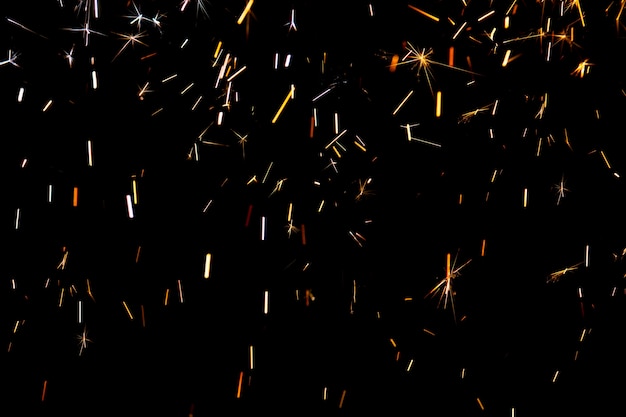 Sparks from firework in front of black backgound