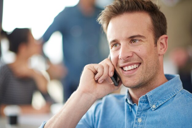 Photo speaking phone call and man in office for consultation with discussion and virtual communication for networking worker guy mobile conversation and talking to contact in agency for deal negotiation