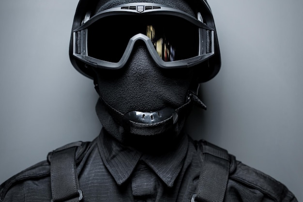 Special Forces in black uniform mask and body armor SWAT Safety goggles for tactical helmet