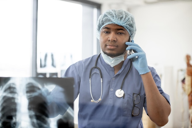 Specialist explaining diagnosis on phone in treatment center