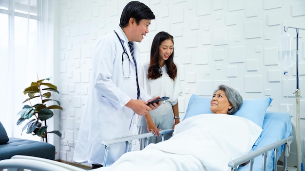 Specialist male doctor describing the improving symptoms of an elderly female patient