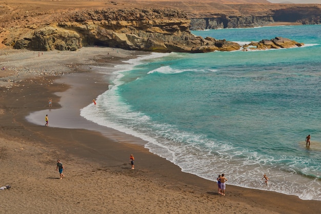 Spectacular black sand beach and mountains with coves in background in Ajuy, Fuerteventura, Canary Islands, Spain