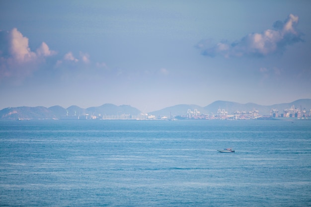 Speedboats sail the industrial coast.