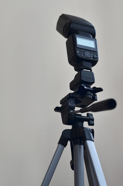 Speedlight gun with trigger set mounted on tripod