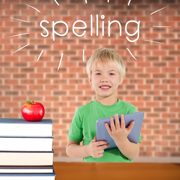 Spelling against red apple on pile of books