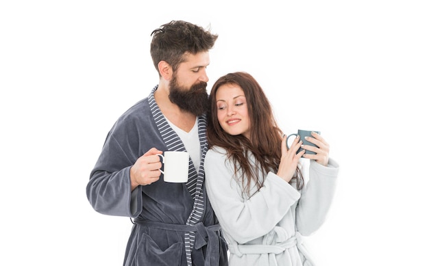 Spending great time at home man and woman need relax and energy everyday routine good morning coffee happy family drink tea couple in love bathrobe Couple enjoy lazy weekend and drink coffee