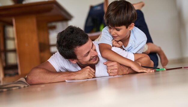 Spending some quality time with his son Full length shot of a father playing with son on the floor at home