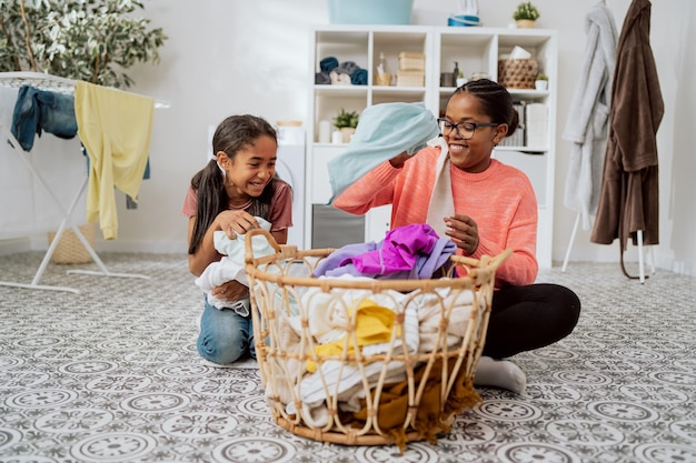 Spending time together while doing household chores mom playing with laughing daughter