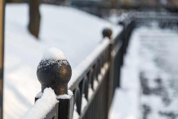 Spherical top of metal decorative fence in the snow.