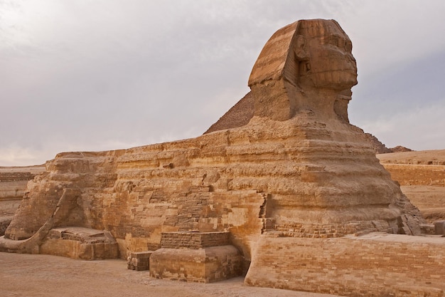 Sphinx against the backdrop of the great Egyptian pyramids Africa Giza Plateau