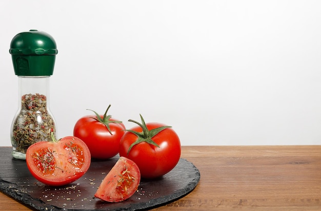 Spice bottle and fresh tomatoes on the kitchen table