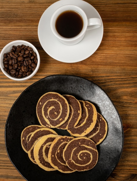 Spice cinnamon cookie with chocolate, zest and nuts filling on wood background. Brown and white round soft biscuits, ginger molasses cookies, christmas gingersnap