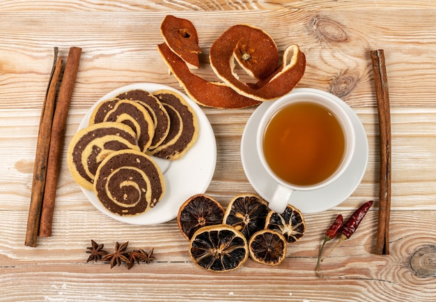 Spice cinnamon cookie with chocolate, zest and nuts filling on wood background top view. Brown and white round soft biscuits, ginger molasses cookies, christmas gingersnap