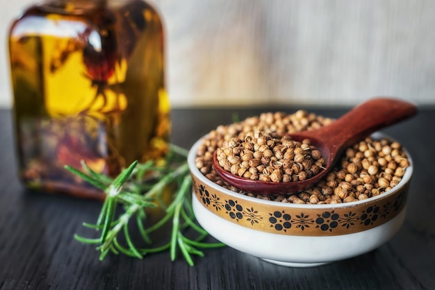 Spice coriander seeds in a wooden spoon