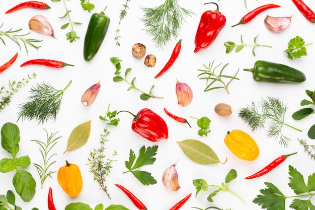 Spice herbal leaves and chili pepper on white. Vegetables pattern. Floral and vegetables on white. Top view, flat lay.