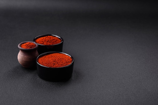 Spice smoked paprika in the form of powder in bowls and spoons